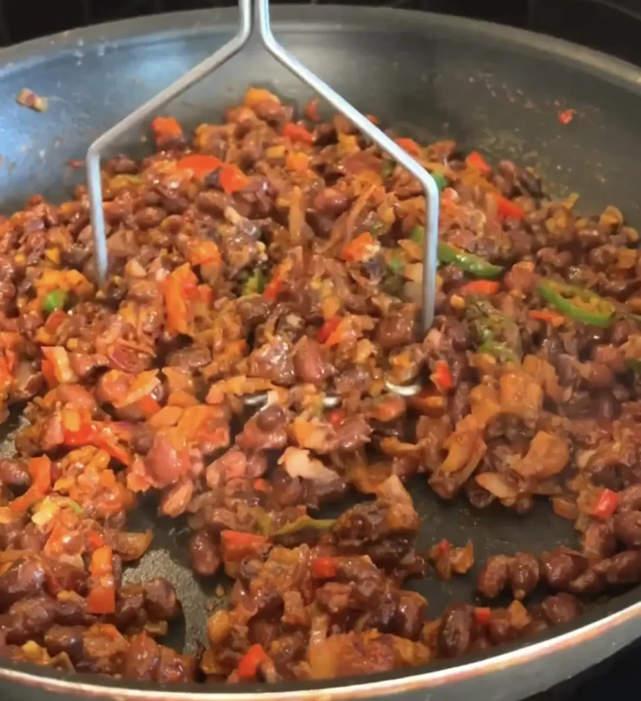 Crispy Black Bean Tacos: Sauté chopped onion, minced garlic, and diced red bell pepper.
