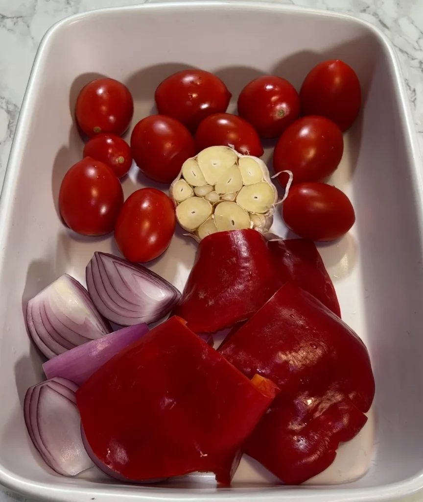 cherry tomatoes, red bell pepper (diced), chopped onion, garlic (3 cloves or to your liking), dried oregano, a pinch of salt, pepper, or chili flakes if desired, drizzled olive oil over the mix